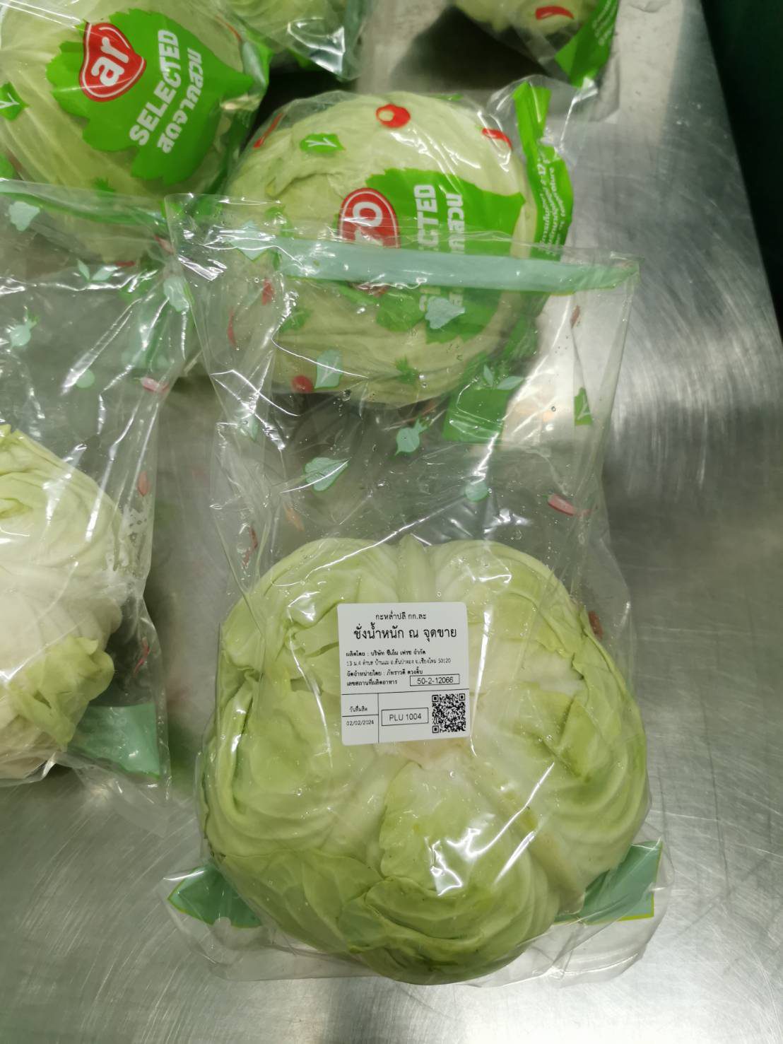 Cabbage in printed retail packaging on the packing table